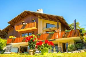 a house with flowers in front of it at Stylish place-Amazing Views-3 main lifts, Apt design- vue splendide-3 Telecabines in Samoëns