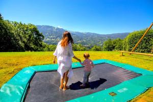 a woman and a child playing on a trampoline at Stylish place-Amazing Views-3 main lifts, Apt design- vue splendide-3 Telecabines in Samoëns