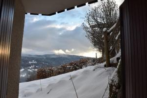 a view of a snow covered hill with a window at Stylish place-Amazing Views-3 main lifts, Apt design- vue splendide-3 Telecabines in Samoëns