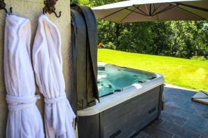 a jacuzzi tub with towels hanging on a wall at Stylish place-Amazing Views-3 main lifts, Apt design- vue splendide-3 Telecabines in Samoëns