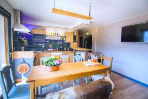 a kitchen with a wooden table and a dining room at Stylish place-Amazing Views-3 main lifts, Apt design- vue splendide-3 Telecabines in Samoëns