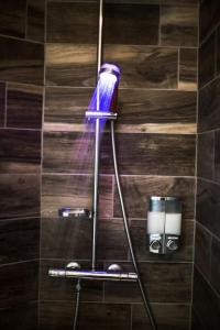 a purple shower head on a wall in a bathroom at Stylish place-Amazing Views-3 main lifts, Apt design- vue splendide-3 Telecabines in Samoëns