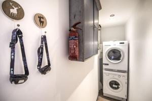 a room with a washing machine and a fire extinguisher at Stylish place-Amazing Views-3 main lifts, Apt design- vue splendide-3 Telecabines in Samoëns