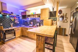 a kitchen with a wooden table and a refrigerator at Stylish place-Amazing Views-3 main lifts, Apt design- vue splendide-3 Telecabines in Samoëns