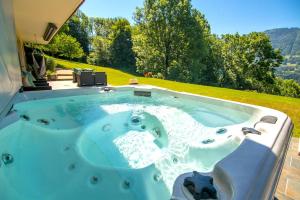 a hot tub in the backyard of a house at Stylish place-Amazing Views-3 main lifts, Apt design- vue splendide-3 Telecabines in Samoëns