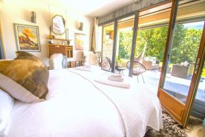a bedroom with a white bed and a large window at Stylish place-Amazing Views-3 main lifts, Apt design- vue splendide-3 Telecabines in Samoëns