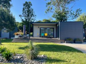 a modular home with a garden at Charming eco-lodge with heated pool and jacuzzi all year round in Charente-Marit in Les Mathes