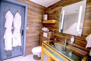 a bathroom with a sink and a toilet and a mirror at Stylish place-Amazing Views-3 main lifts, Apt design- vue splendide-3 Telecabines in Samoëns