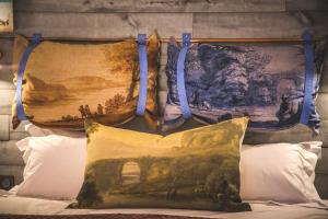a pillow on a bed with a painting on the wall at Stylish place-Amazing Views-3 main lifts, Apt design- vue splendide-3 Telecabines in Samoëns