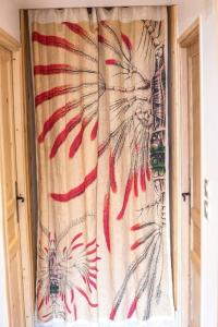 a curtain on a window with a flag at Stylish place-Amazing Views-3 main lifts, Apt design- vue splendide-3 Telecabines in Samoëns