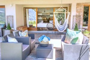 a patio with chairs and a bed in a bedroom at Stylish place-Amazing Views-3 main lifts, Apt design- vue splendide-3 Telecabines in Samoëns