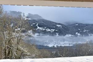 a view of a snow covered mountain with a lake at Stylish place-Amazing Views-3 main lifts, Apt design- vue splendide-3 Telecabines in Samoëns
