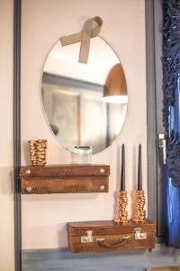 a mirror on a wall next to a table with suitcases at Stylish place-Amazing Views-3 main lifts, Apt design- vue splendide-3 Telecabines in Samoëns