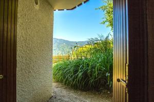an open door with a view of a garden at Stylish place-Amazing Views-3 main lifts, Apt design- vue splendide-3 Telecabines in Samoëns