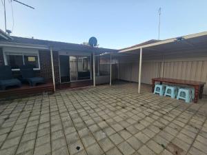 a patio with chairs and a table in front of a house at Entire 3 bedroom personal house in Chipping Norton in Chipping Norton