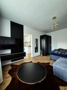 a living room with a table and a couch at Apartmán Lesa Brezno in Brezno