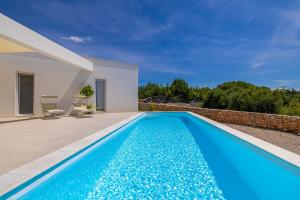 a swimming pool in the backyard of a villa at Villa MENTA IV in Linardići