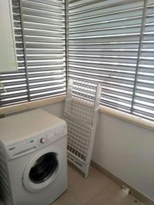 a washing machine in a room with a window at Appartement GALA in Pulpí +5 photos