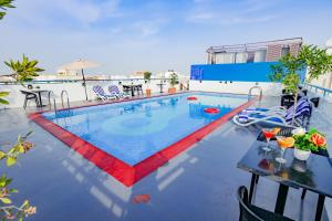 a swimming pool on top of a building at Fortune Pearl Hotel in Dubai