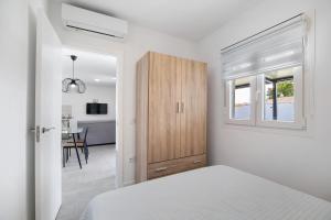 Un dormitorio blanco con una cama y un armario. en Joal Piscina Privada, en Chiclana de la Frontera 13 fotos más