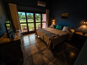 a bedroom with a bed and a large window at Posada Mbarete in San Miguel +41 photos