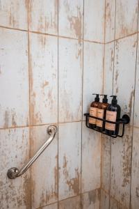 a bathroom with two bottles on a wall at Posada Mbarete in San Miguel
