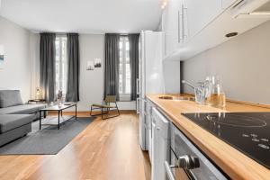 a kitchen and living room with a couch at Forenom Serviced Apartments Oslo Nobel in Oslo