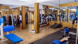 a gym with blue equipment and people in it at Kakanfo Inn & Conference Centre in Ibadan