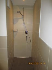a shower with a shower head in a bathroom at Charlys Ferienwohnung in Samnaun +17 photos
