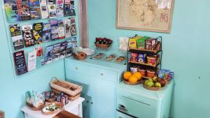 a kitchen with blue cabinets and baskets of food at Lighthouse Cabins Maine in Bass Harbor