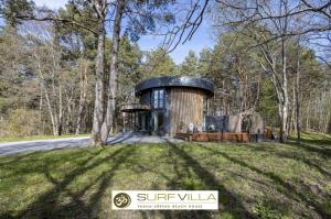a circular house in the middle of a field at Surf Villa in Vääna-Jõesuu