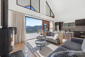 a living room with a couch and a table at Black Tusk - Merrijig - Sleeps 8 in Merrijig