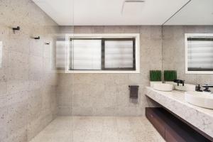 a bathroom with two sinks and two mirrors at Black Tusk - Merrijig - Sleeps 8 in Merrijig +19 photos