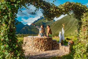 a man and woman standing on top of a cake at Inkasaire Boutique Lodge in Urubamba