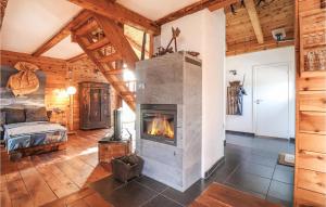 a living room with a fireplace in a log cabin at Ferienhaus In Mühldorf in Mühldorf