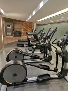 a gym with rows of exercise bikes and treadmills at Shore 3 tower 2 mall of Asia in Manila