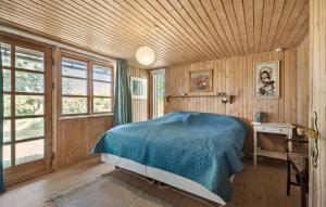 a bedroom with a bed and a desk and windows at Cozy Home In Korsør With Kitchen in Korsør