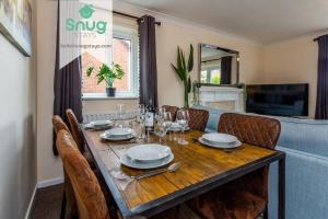 a dining room table with chairs and a dining room at Hardwick House 3 bed with parking for Contractors & Tourists in Gateshead