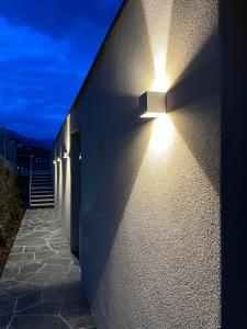 a wall with a light on the side of a building at Boutique Hotel La Rocca in Ronco s/Ascona - Porto Ronco