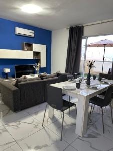 una sala de estar con una mesa y un sofá en Luxury penthouse in Sliema, en Sliema