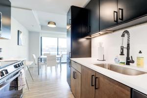a kitchen with black cabinets and a sink at 2BR Executive Apartment in Prime Location in Arlington
