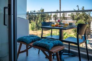 a balcony with a table and chairs on a balcony at Litinakis Studios Sea View & Litinakis Studios Garden View 700 meters away in Agia Marina Nea Kydonias