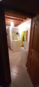 a room with a kitchen with a white refrigerator at Gîte de la liberté in Sainte-Marie-du-Mont