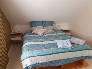 Un dormitorio pequeño con una cama con una manta de rayas. en Appartement cosy proche centre, en Colmar