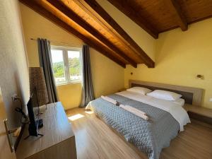 a bedroom with a bed and a television in it at Apartment MORE Island Vis in Vis