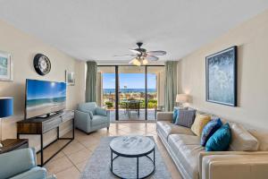 a living room with a couch and a tv at Bluewater Unit 104 in Orange Beach