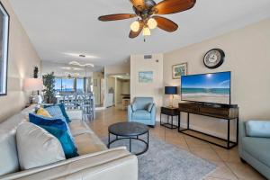 a living room with a couch and a flat screen tv at Bluewater Unit 104 in Orange Beach +73 photos