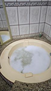 a bath tub filled with water in a bathroom at Area de lazer Lua e Sol in Franca