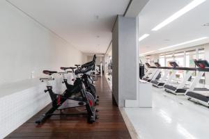 einen Fitnessraum mit Fahrrädern, die in einem Zimmer geparkt sind in der Unterkunft Incrível Studio 308 - Batel CWB (melhor localização) in Curitiba