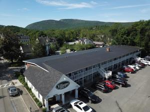 a building with cars parked in a parking lot at Bar Harbor Villager Motel - Downtown in Bar Harbor